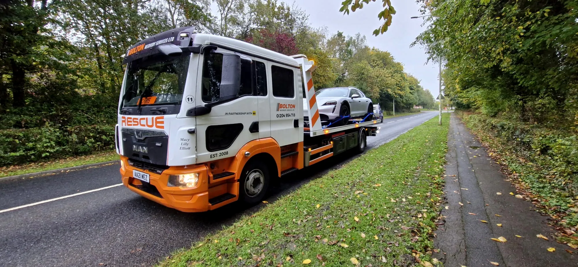 Car secured on a Bolton Recovery Services flatbed for safe vehicle transport across Greater Manchester